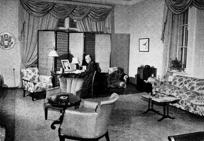 The Great Seal is visible to the left, on the office wall beyond the Ambassador's desk.