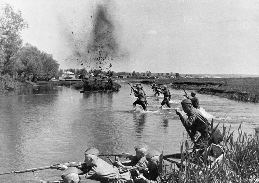 1943: Sovjetinfanterie wordt onder vuur genomen tijdens het oversteken van de Oekraïense rivier. Foto: Sovfoto / Getty Images